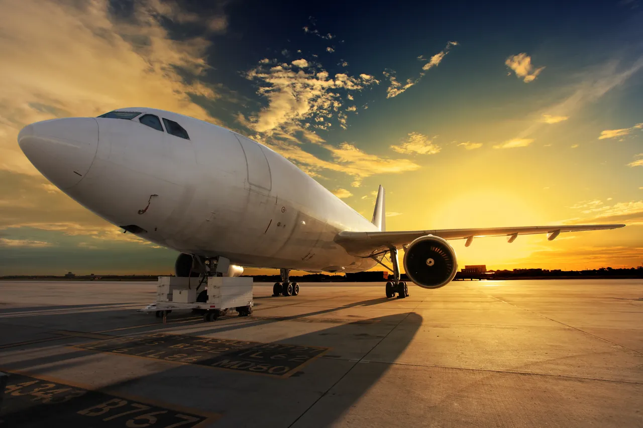 An airliner on the apron at sunset